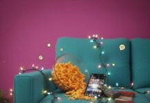 Top 20 TV Shows Everyone’s Talking About in 2025 Couch with Cheetos, iPhone, Christmas lights, and a sock.