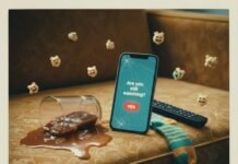 How to Build the Perfect Weekend Streaming Watch list? Iced coffee spilled on a couch, a phone on Netflix, and a sock.