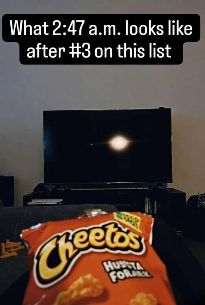 Late-night TV glow on Cheetos, single eye reflection. 2:47 a.m. Late-night TV glow on Cheetos, single eye reflection. 2:47 a.m.
